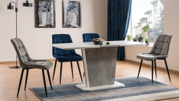 Masywny stół jadalniany z płyty laminowanej imitującej beton oraz pikowane krzesła tapicerowane