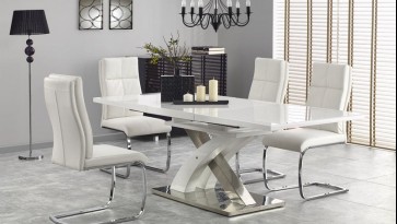 Rozkładany stół w wysokim połysku na designerskiej podstawie w towarzystwie wygodnych krzeseł z pikowanej ekoskóry