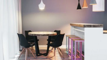 Okrągły stół z drewnianym blatem w stylu industrialnym w towarzystwie krzeseł na drewnianych nogach