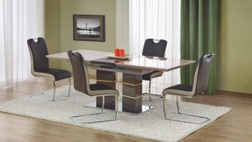 Rozkładany stół w wysokim połysku na ozdobnej podstawie z krzesłami na płozach i z rączką ułatwiającą odsuwanie od stołu