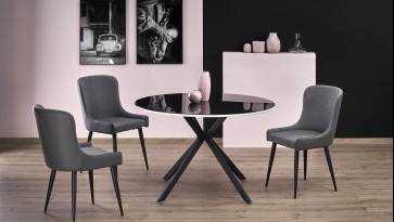 Stół z okrągłym blatem ze szkła na stylowej podstawie oraz tapicerowane krzesła