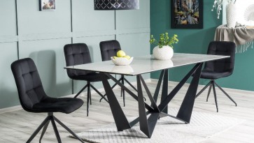 Designerski stół nierozkładany z krzesłami tapicerowanymi tkaniną aksamitną w jadalni o zielonych ścianach