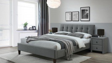 Szare łóżko sypialniane na czarnych nogach z pikowanym wezgłowiem i tapicerowane szafki nocne