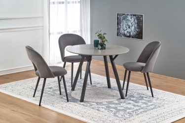 Okrągły stół do jadalni w towarzystwie tapicerowanych tkaniną krzeseł