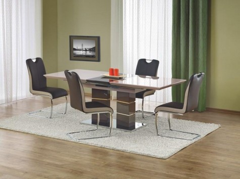 Rozkładany stół w wysokim połysku na ozdobnej podstawie z krzesłami na płozach i z rączką ułatwiającą odsuwanie od stołu