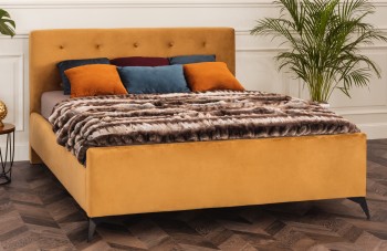 Tapicerowane łóżko z pikowanym wezgłowiem na wysokich nóżkach Milos